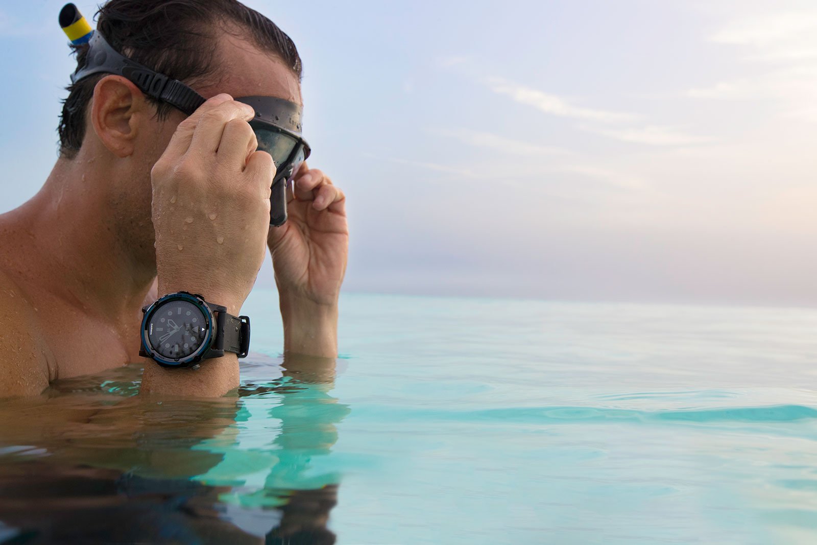 man wearing a watch and diving in the sea